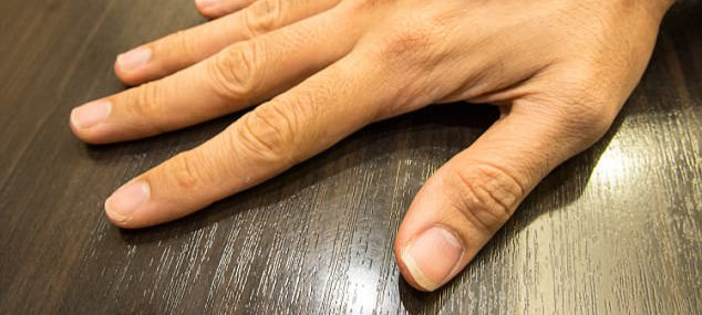 Hand on a wooden surface